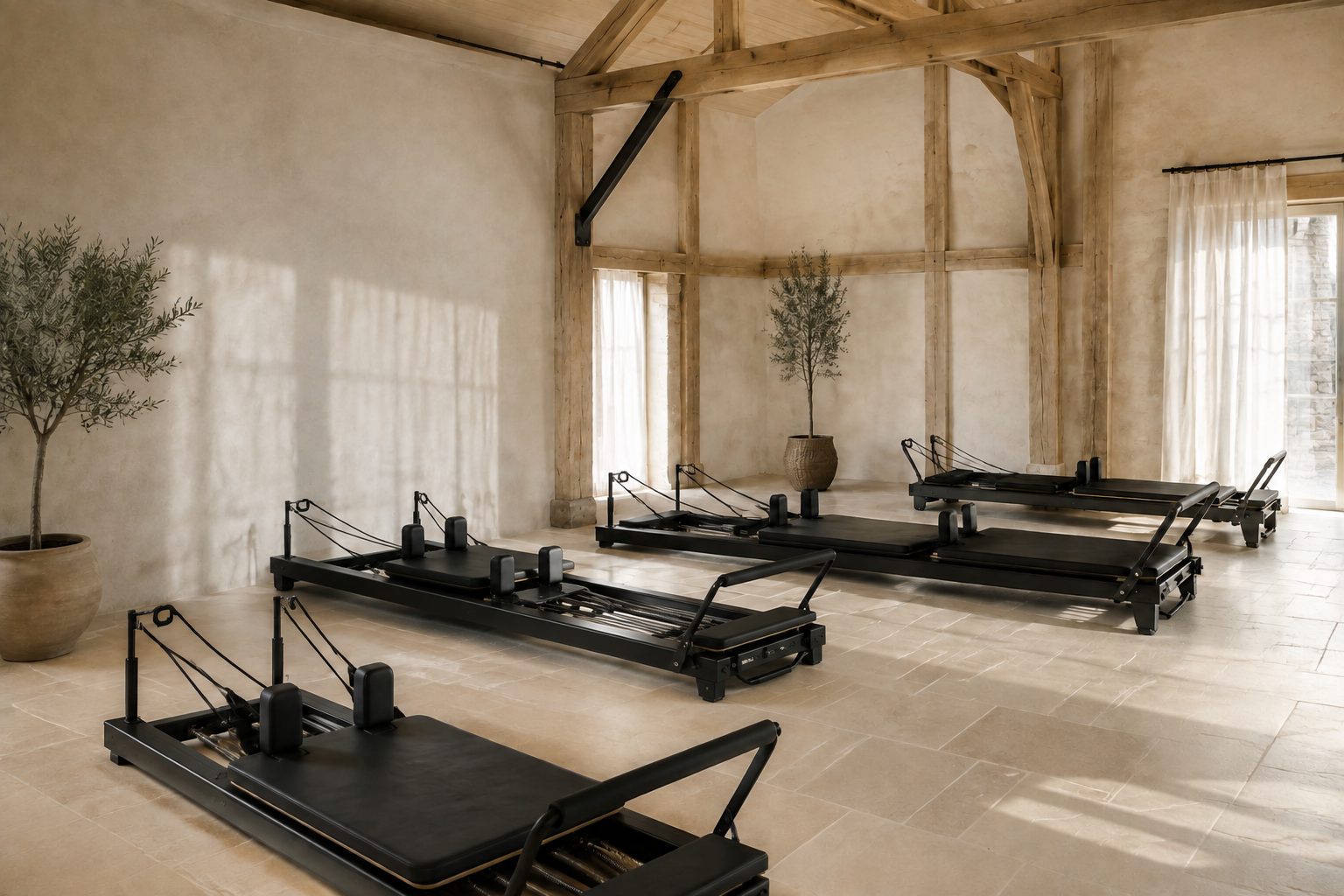A calm boutique barn studio with five Reformer Pilates machines